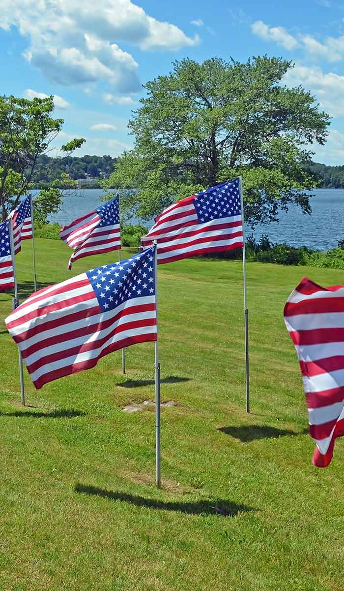 American flags flying on a grassy lawn